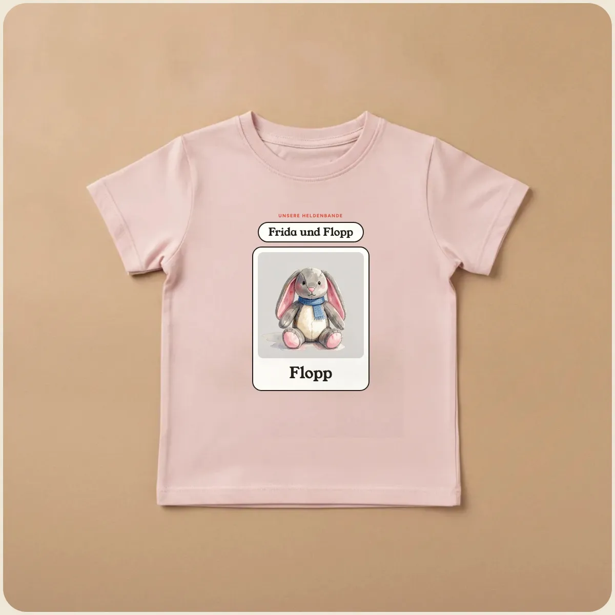 Hellrosa Kinder-T-Shirt mit einem Helden: Kuscheltier Flopp